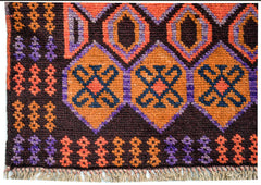 Handmade Afghan Pashm rug featuring geometric diamond patterns in orange, purple, and dark brown.