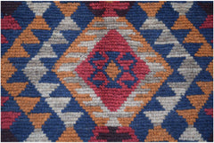 Handmade Afghan Pashm rug featuring a geometric diamond pattern in red, blue, and ivory wool.
