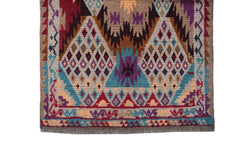 Handmade Afghan Pashm rug featuring geometric diamond patterns in red, blue, and brown wool.