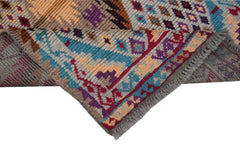 Handmade Afghan Pashm rug featuring a tribal geometric pattern in red, blue, and brown wool.