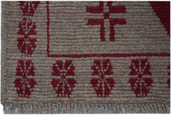 A handmade Afghan Pashm rug featuring a brown wool base with geometric red tribal patterns.
