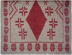 Handmade Afghan Pashm rug featuring a central red diamond motif on a tan wool background.