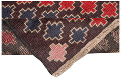 A handmade Afghan Pashm rug featuring a geometric pattern in dark red, blue, and pink on brown.