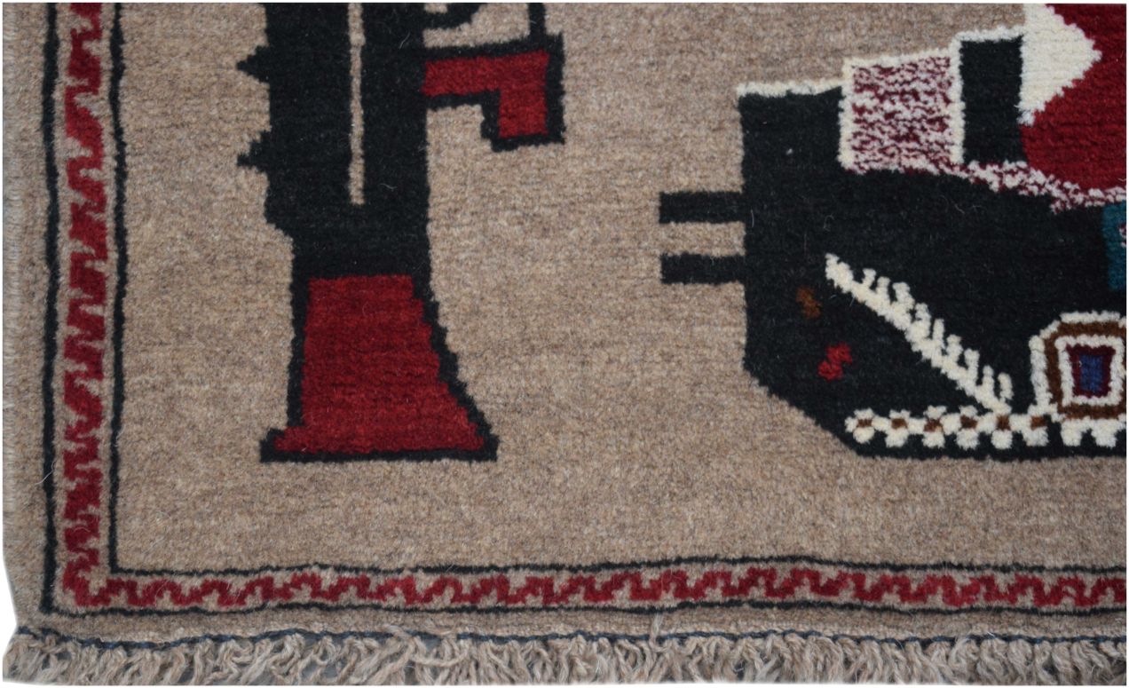 A handmade Afghan wool rug featuring geometric patterns and military-themed motifs.