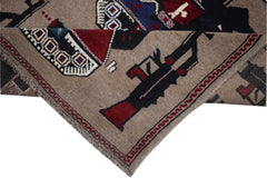 Handmade Afghan wool rug featuring stylized depictions of firearms and geometric patterns.