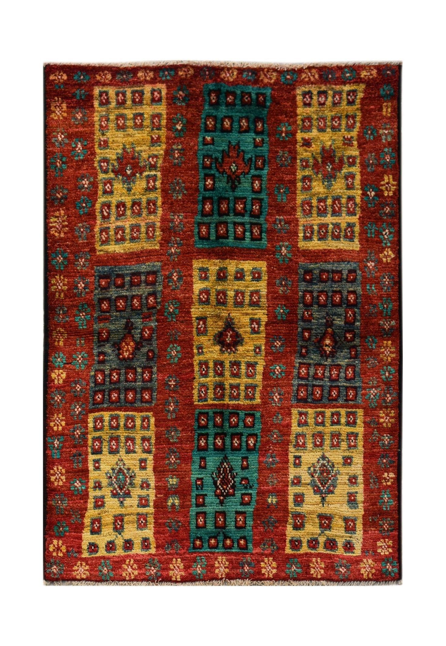 Hand-knotted Afghan wool rug featuring a red background with geometric yellow and teal panels.