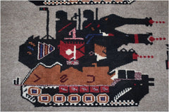 Handmade Afghan wool rug featuring a stylized black tank with red and blue geometric details.
