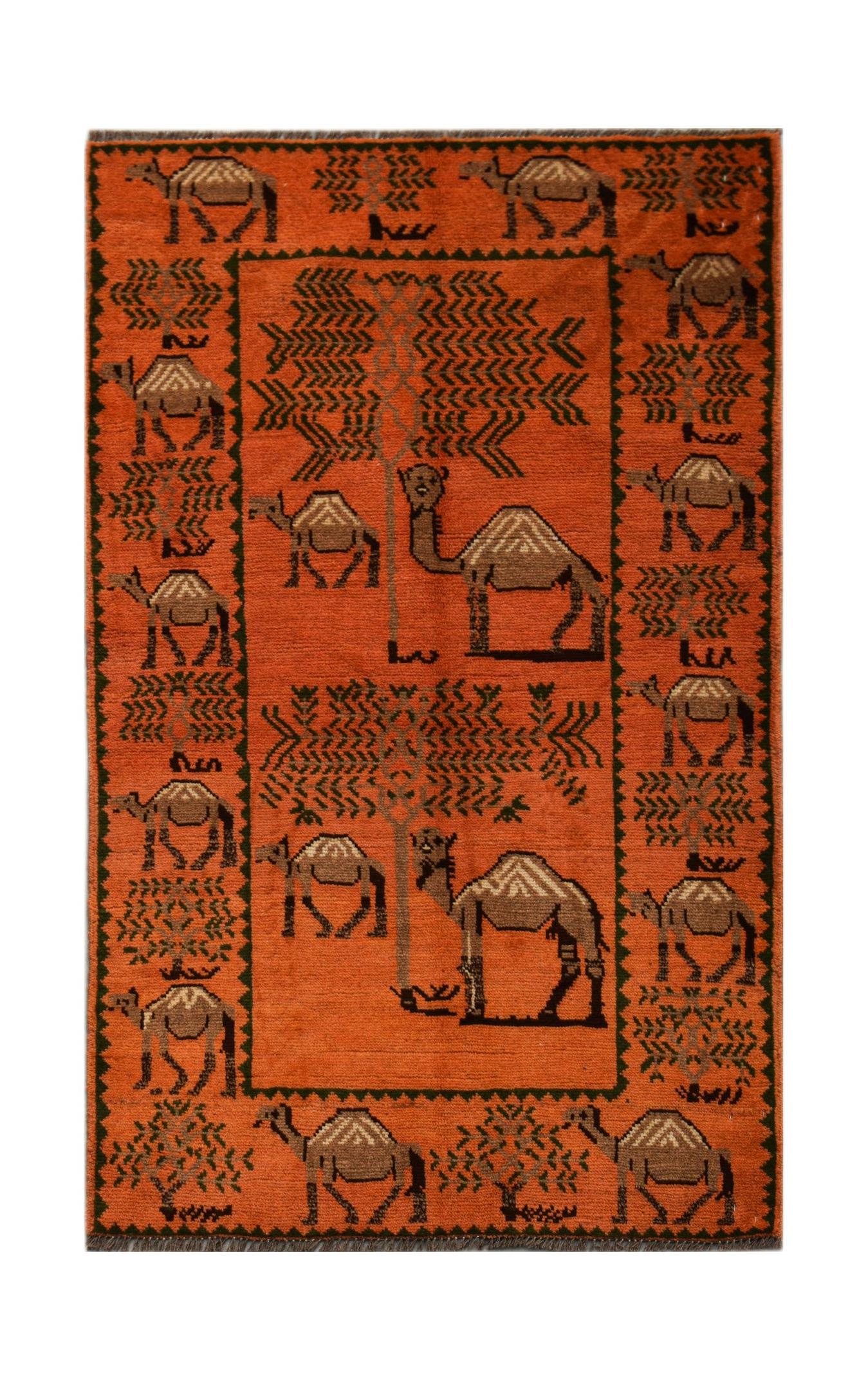 An orange hand-knotted Afghan wool rug featuring a repeating pattern of camels and trees.