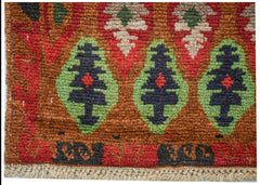 Handmade Afghan Pashm rug featuring a tribal pattern of dark blue and green geometric motifs.