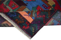 A handmade Afghan Pashm rug featuring a colorful village scene with a dark floral border.