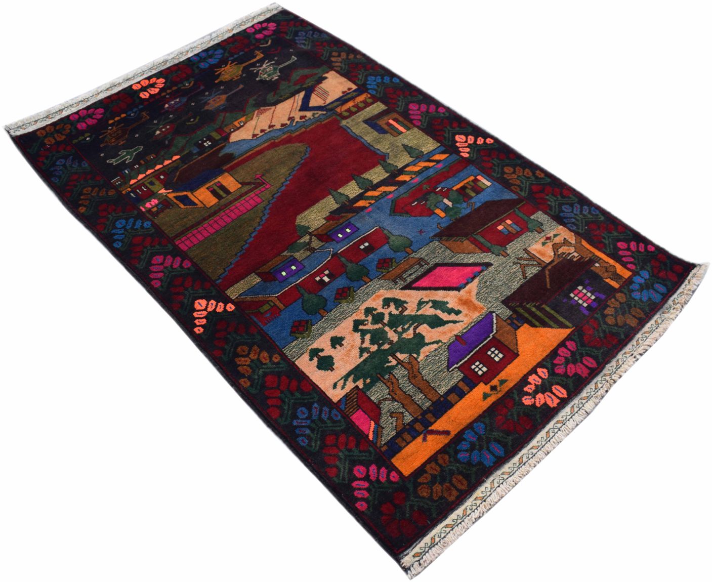 A handmade Afghan wool rug featuring a colorful landscape scene with houses and trees.