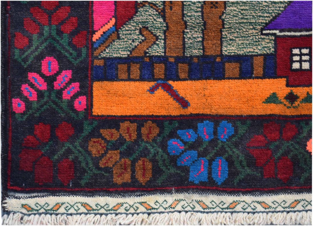 A handmade Afghan wool rug featuring a dark border with floral patterns and a vibrant orange field.