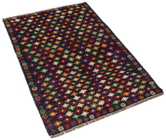A handmade Afghan Pashm rug featuring a dark background with a repeating pattern of colorful floral motifs.