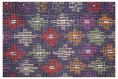 Handmade Afghan Pashm rug featuring a dark blue field with a repeating pattern of colorful motifs.