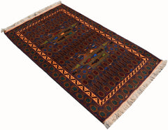 Handmade Afghan wool rug featuring a dark field with geometric patterns and a fringed edge.