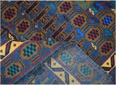 A handmade Afghan wool rug featuring a geometric pattern in blue, gold, red, and green.