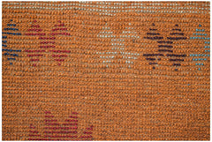Handmade Afghan Pashm rug featuring a textured orange wool base with geometric tribal patterns.