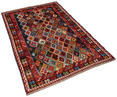 Handmade Afghan Pashm rug featuring a colorful diamond pattern on a dark background.
