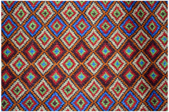 Handmade Afghan Pashm rug featuring a repeating diamond pattern in red, blue, and ivory wool.