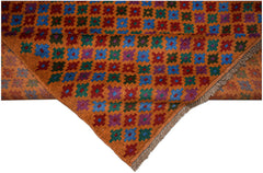 An Afghan Pashm rug featuring a repeating geometric floral pattern in blue, red, green, and purple.