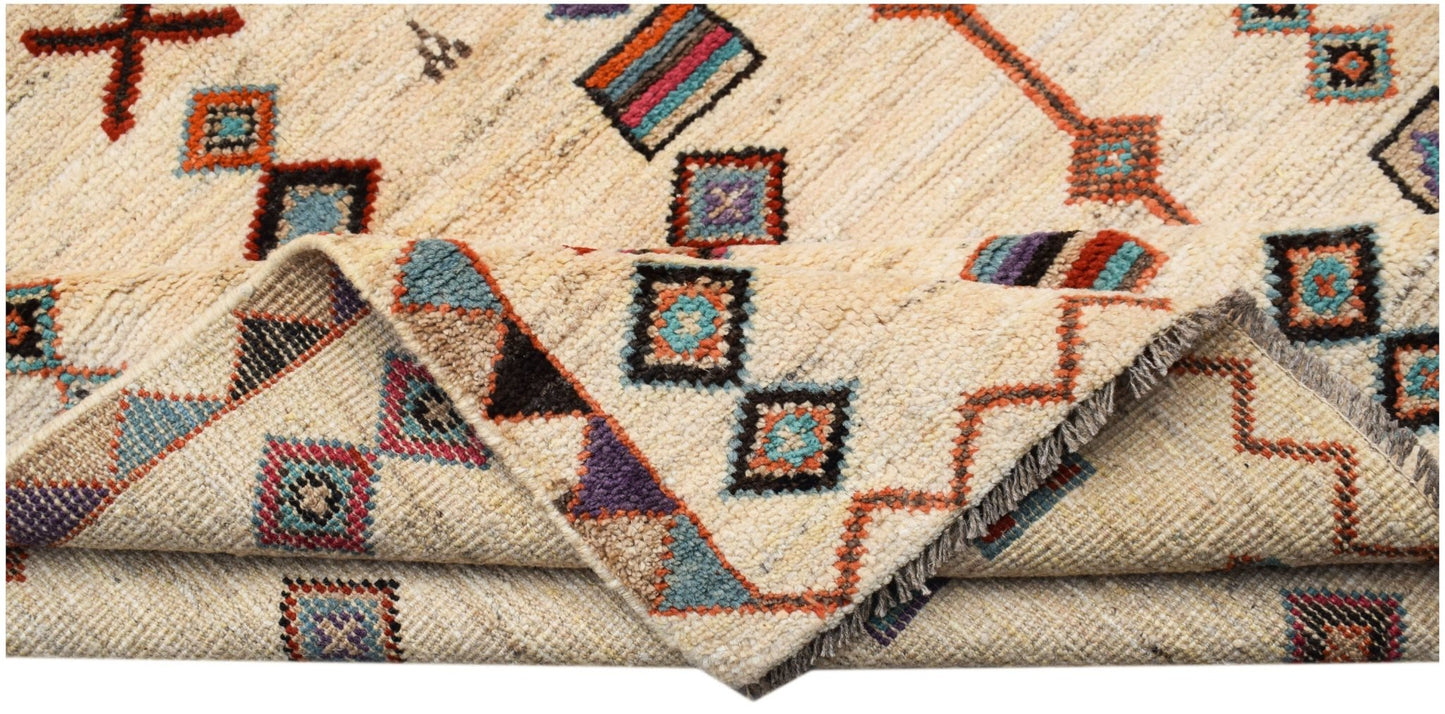 A hand-knotted Afghan wool rug featuring a cream background with colorful geometric patterns.