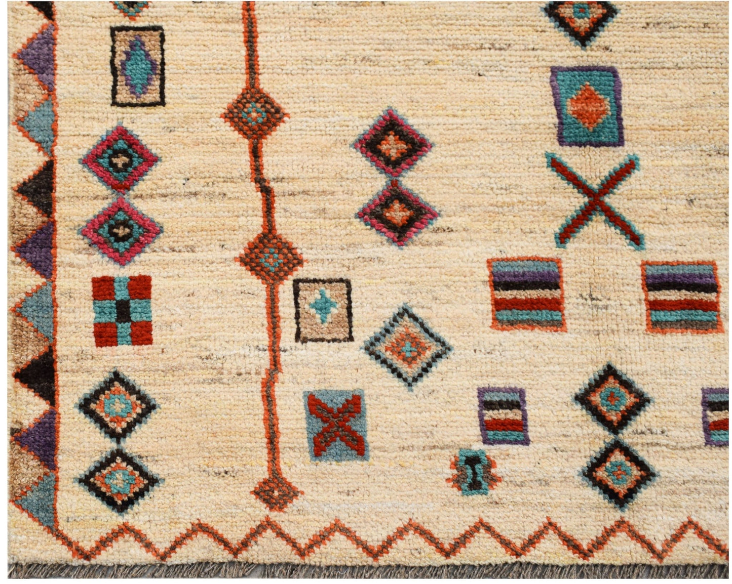 Hand-knotted Afghan wool rug featuring a cream field with colorful geometric tribal motifs.