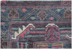 A handmade Afghan Pashm rug featuring a dark blue and brown geometric tribal pattern.