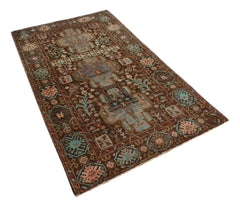 A handmade Afghan Pashm rug featuring geometric tribal patterns in shades of brown, blue, and pink.