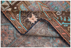 A handmade Afghan Pashm rug featuring a tribal pattern in shades of brown, blue, and orange.