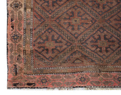 Handmade Afghan Pashm rug featuring a geometric diamond pattern in shades of red, brown, and blue.