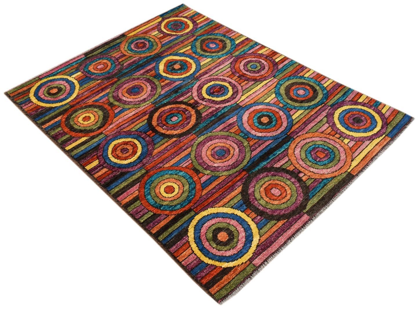 A hand-knotted Afghan wool rug featuring a vibrant, multicolored pattern of concentric circles.