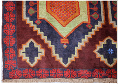 Handmade Afghan Pashm rug featuring a geometric pattern in dark red, blue, and lime green.