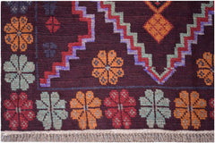 Handmade Afghan Pashm rug featuring geometric floral patterns in orange, red, and blue on dark wool.