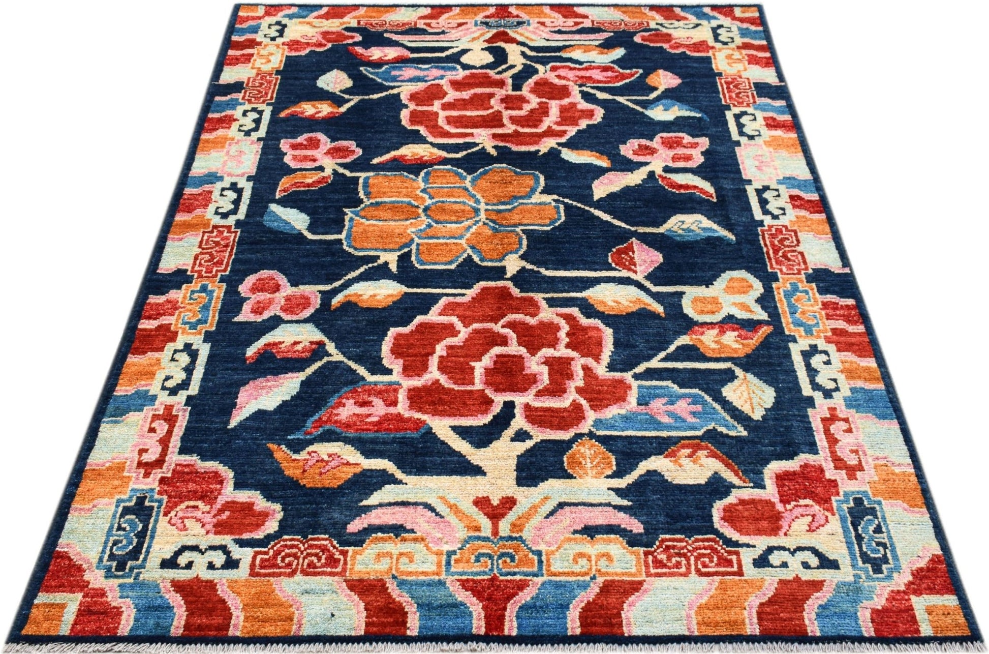 Hand-knotted Afghan wool rug featuring a dark blue field with large red and orange floral motifs.