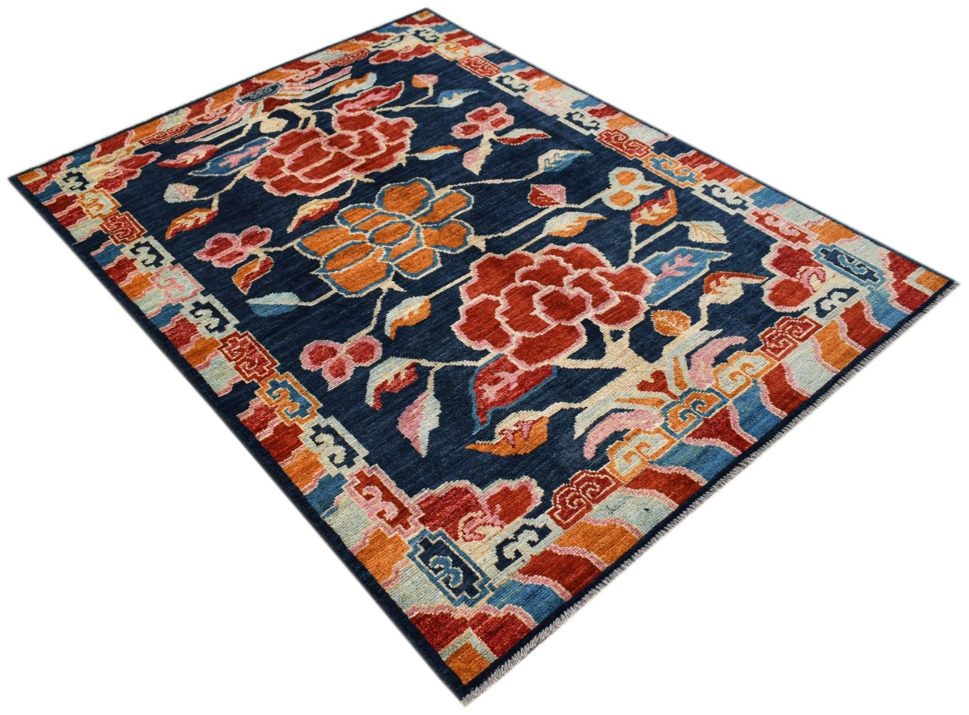 A hand-knotted Afghan wool rug featuring a dark blue field with floral motifs and geometric borders.