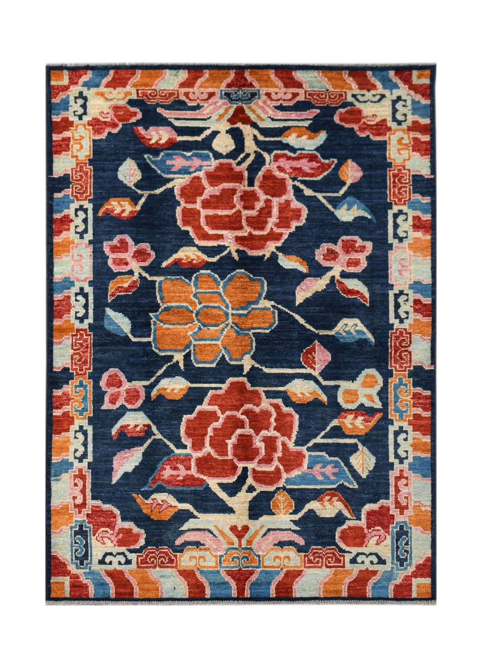 Hand-knotted Afghan wool rug featuring a dark blue field with floral motifs and geometric borders.