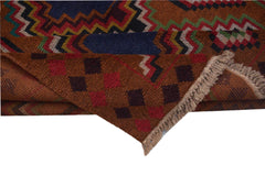 A handmade Afghan Pashm rug featuring a geometric pattern in shades of brown, red, and blue.