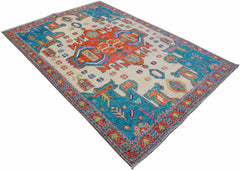 A handmade Afghan Pashm wool rug featuring a vibrant tribal pattern in orange, blue, and cream.