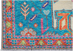 Handmade Afghan Pashm rug featuring a vibrant blue field with colorful floral and tribal motifs.