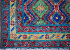 Handmade Afghan Pashm rug featuring a vibrant geometric pattern in red, green, blue, and yellow.