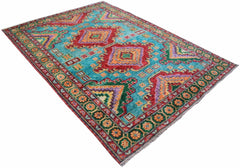 A handmade Afghan wool rug featuring a vibrant geometric pattern in red, green, and orange.