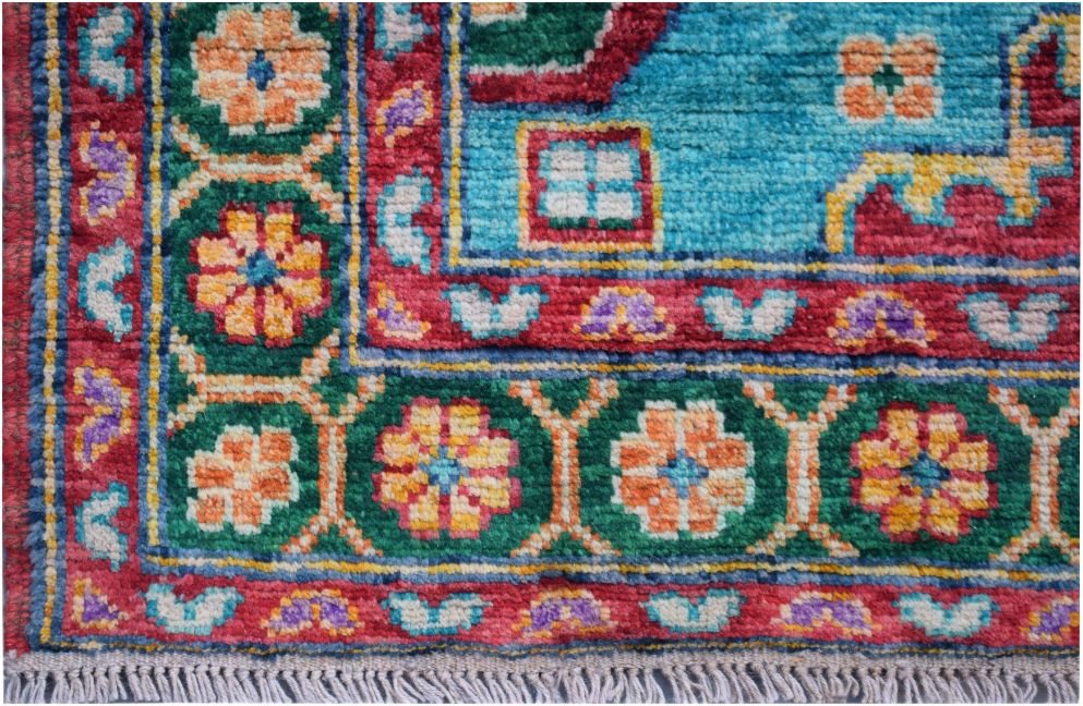 Handmade Afghan Pashm wool rug featuring a vibrant floral pattern in red, green, and blue.