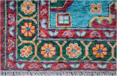 Handmade Afghan Pashm wool rug featuring a vibrant floral pattern in red, green, and blue.