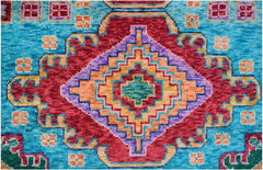 Handmade Afghan wool rug featuring a vibrant geometric diamond pattern in red, blue, and orange.