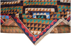 A handmade Afghan Pashm rug featuring a geometric tribal pattern in shades of red, blue, and brown.