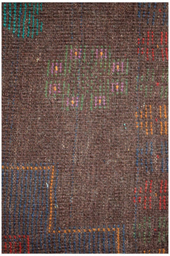 Handmade Afghan Pashm rug featuring a dark brown wool base with colorful geometric accents.