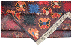 A handmade Afghan Pashm rug featuring geometric floral motifs in red, blue, and brown wool.