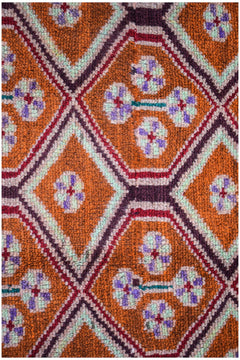 Afghan Pashm rug with a diamond pattern in orange, purple, and mint green.