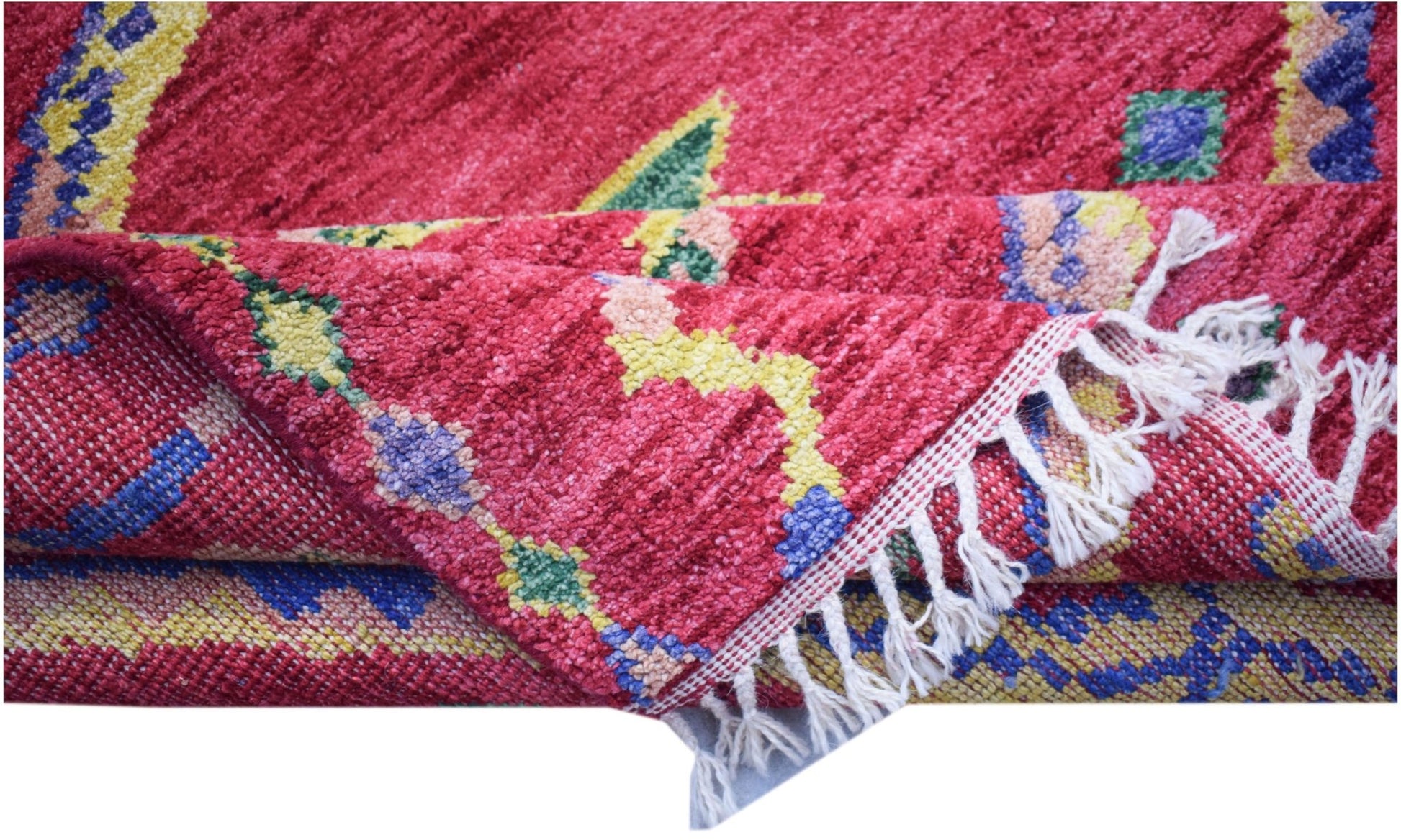 A hand-knotted Afghan wool rug featuring a vibrant red field with bold geometric patterns.
