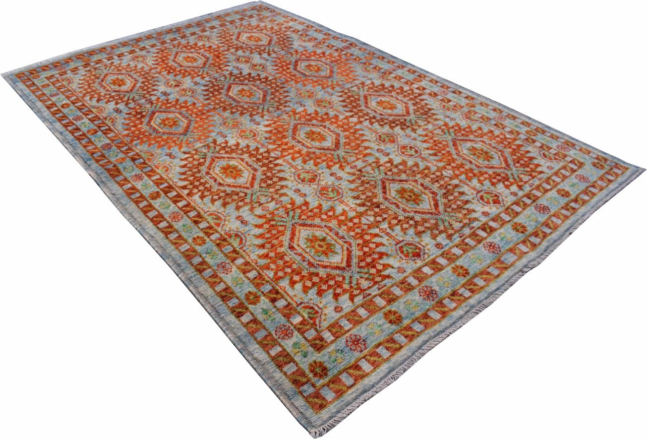 Handmade Afghan Pashm wool rug featuring a traditional tribal pattern in orange and blue tones.